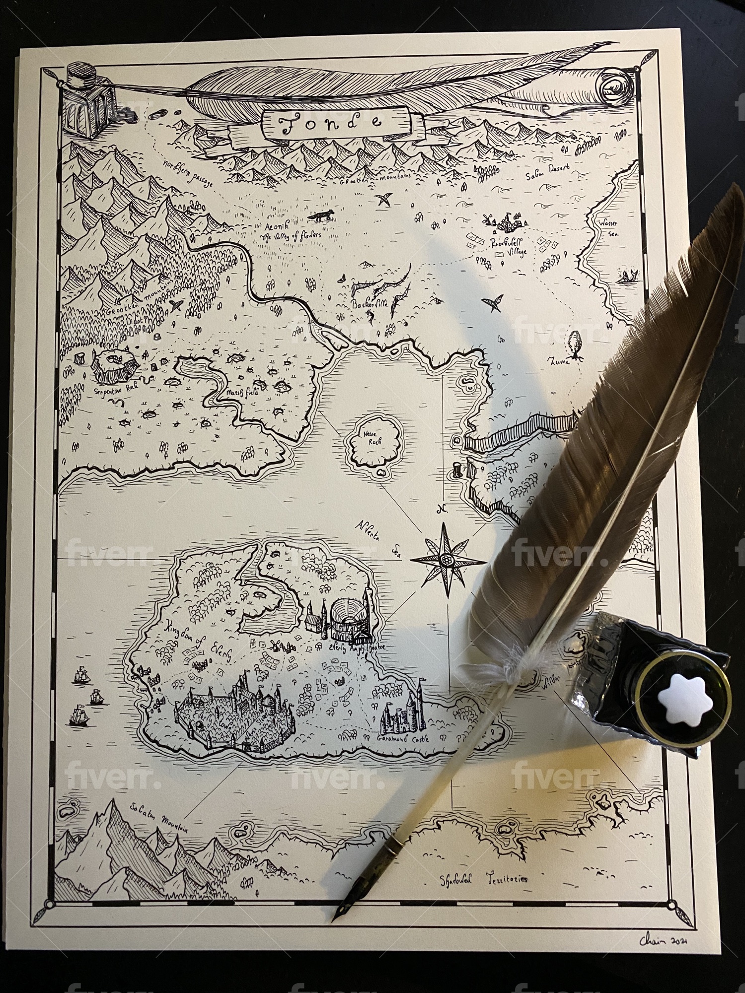 Completed hand-drawn Pennymores world map beside a feather quill and ink bottle